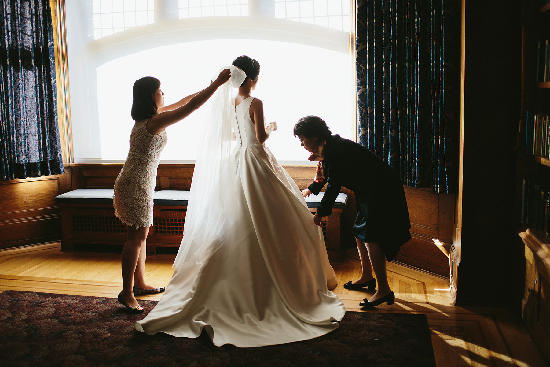 a Vancouver bride gets dressed in the Cecil Green Park House library www.lucida-photography.com