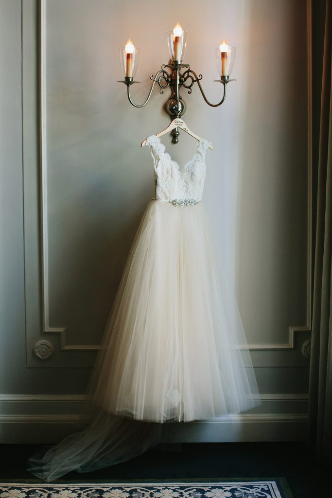 wedding dress on custom hanger hanging in georgian room of vancouver club www.lucida-photography.com