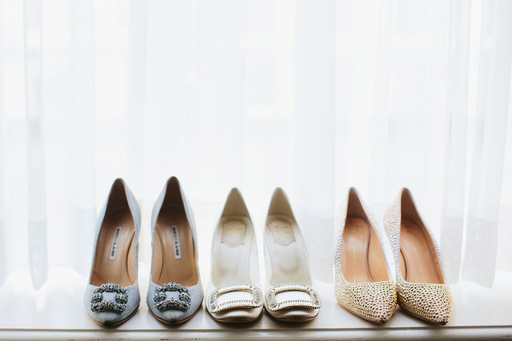 three pairs of wedding shoes in the window sill of the vancouver club www.lucida-photography.com