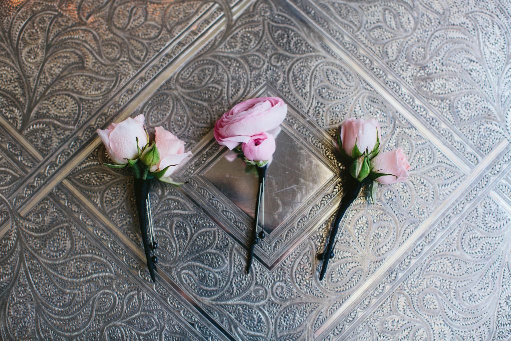 pink wedding boutonnieres lay on a vintage silver tray at the vancouver club www.lucida-photography.com