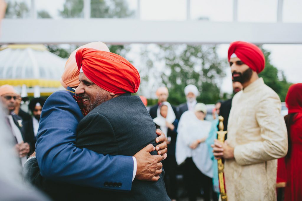 fathers embrace at milni ceremony Akali Singh Sikh society www.lucida-photography.com