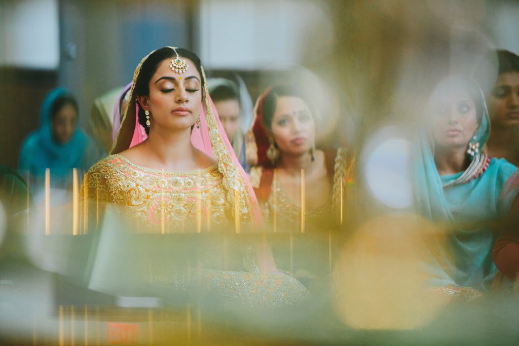 A Sikh bride sits during Vancouver wedding ceremony www.lucida-photography.com