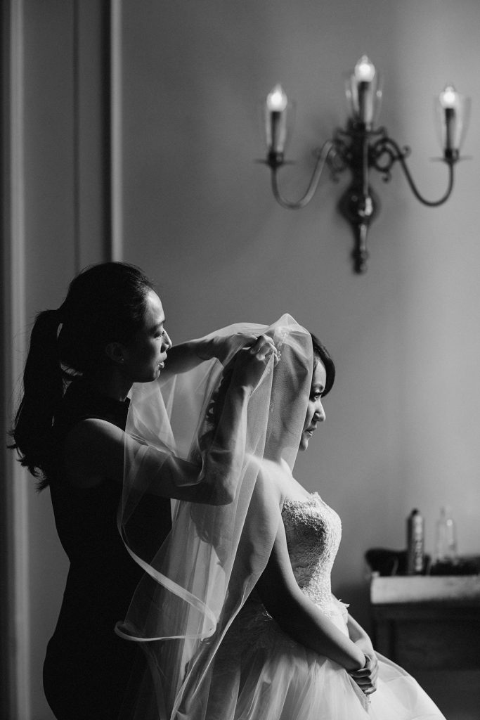 bride puts gets dressed and has veil pinned in georgian room of vancouver club www.lucida-photography.com