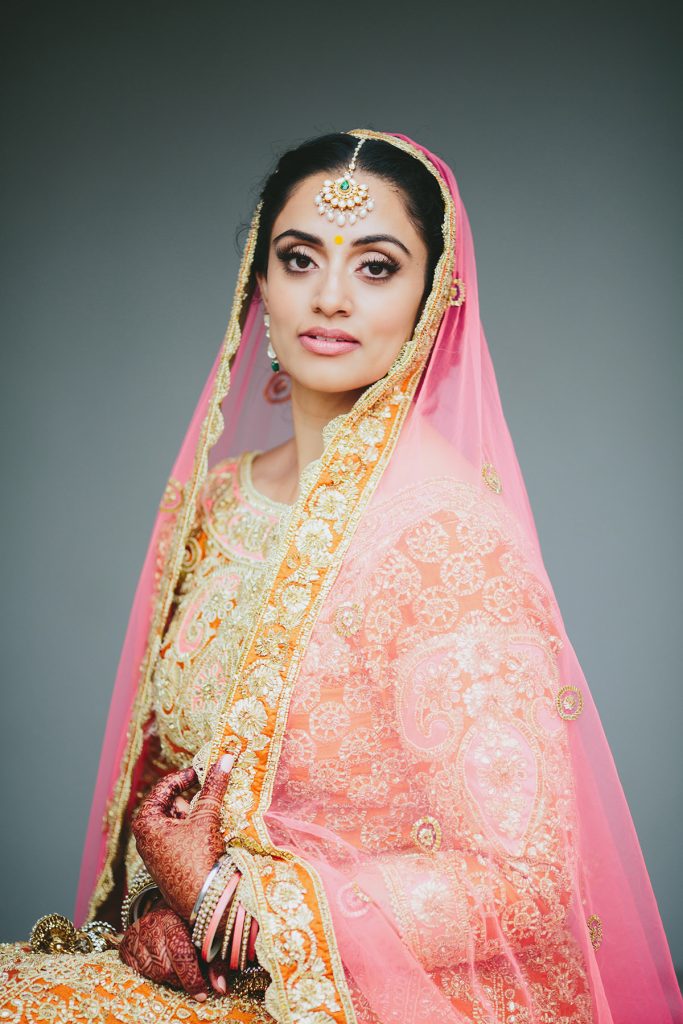 Portrait of and Indian bride in Pink gold and orange in Vancouver www.lucida-photography.com
