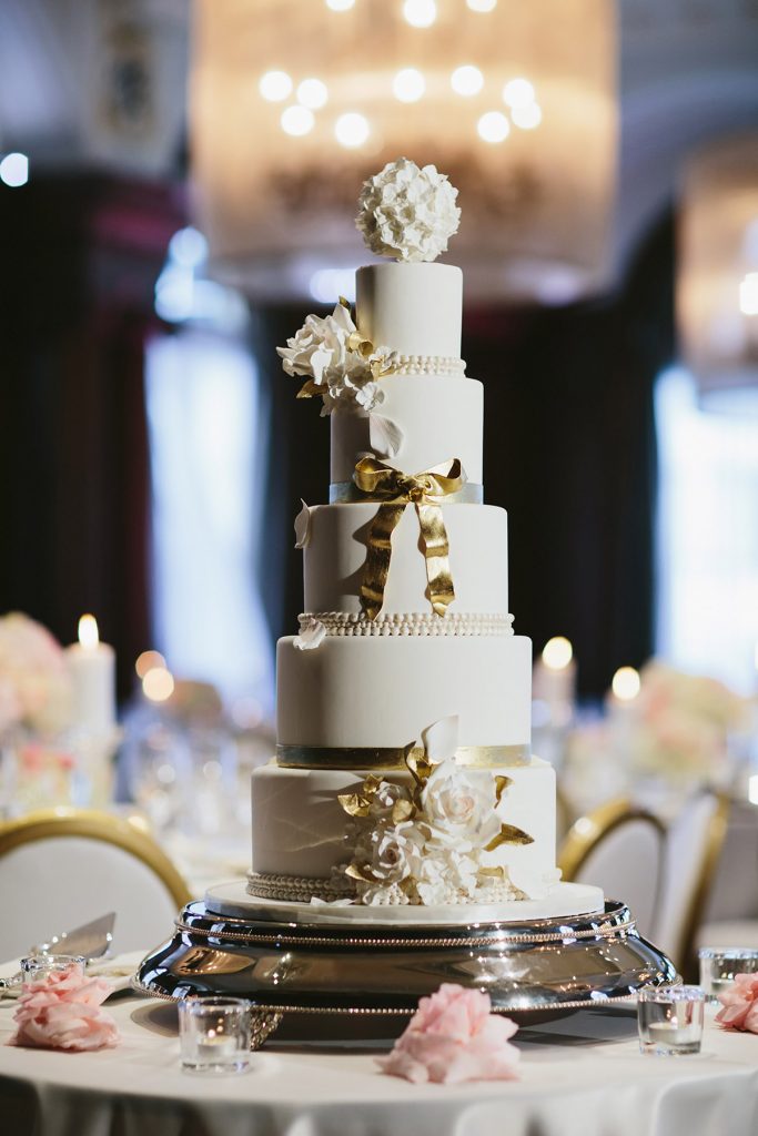 gold and ivory white five tiered wedding cake at the vancouver club www.lucida-photography.com