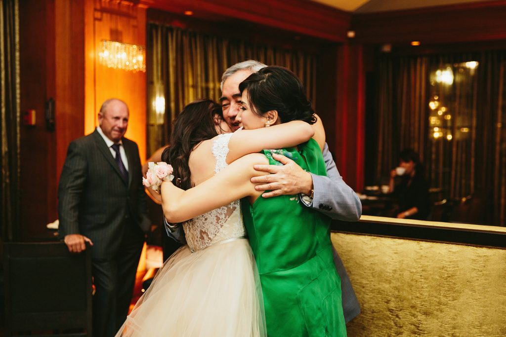 a bride hugs her parents at her vancouver club reception www.lucida-photography.com
